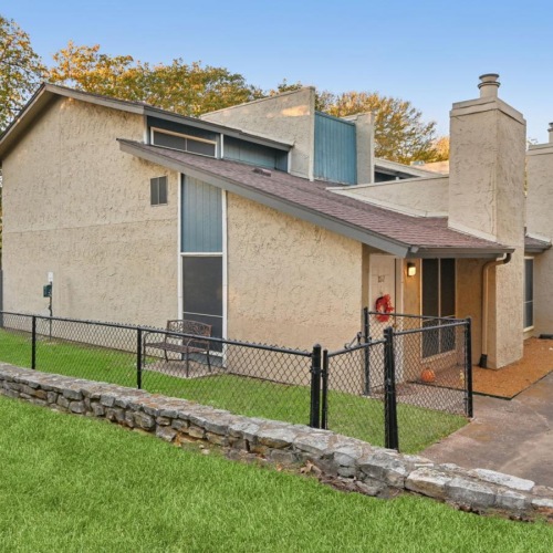 We welcome all your furry friends a house with a fence around it