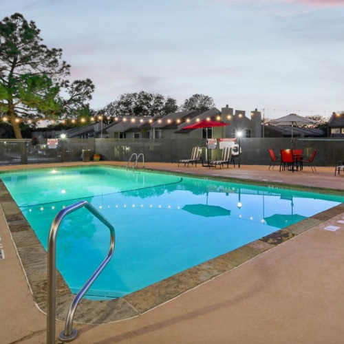 Resort-style swimming pool a pool with a deck and chairs around it