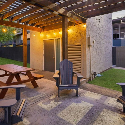 Access to resident-only features a patio with a table and chairs